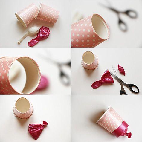 材料:卫生纸筒(或去底的纸杯),气球,胶带,剪刀,彩纸三,烟花炮也可以用