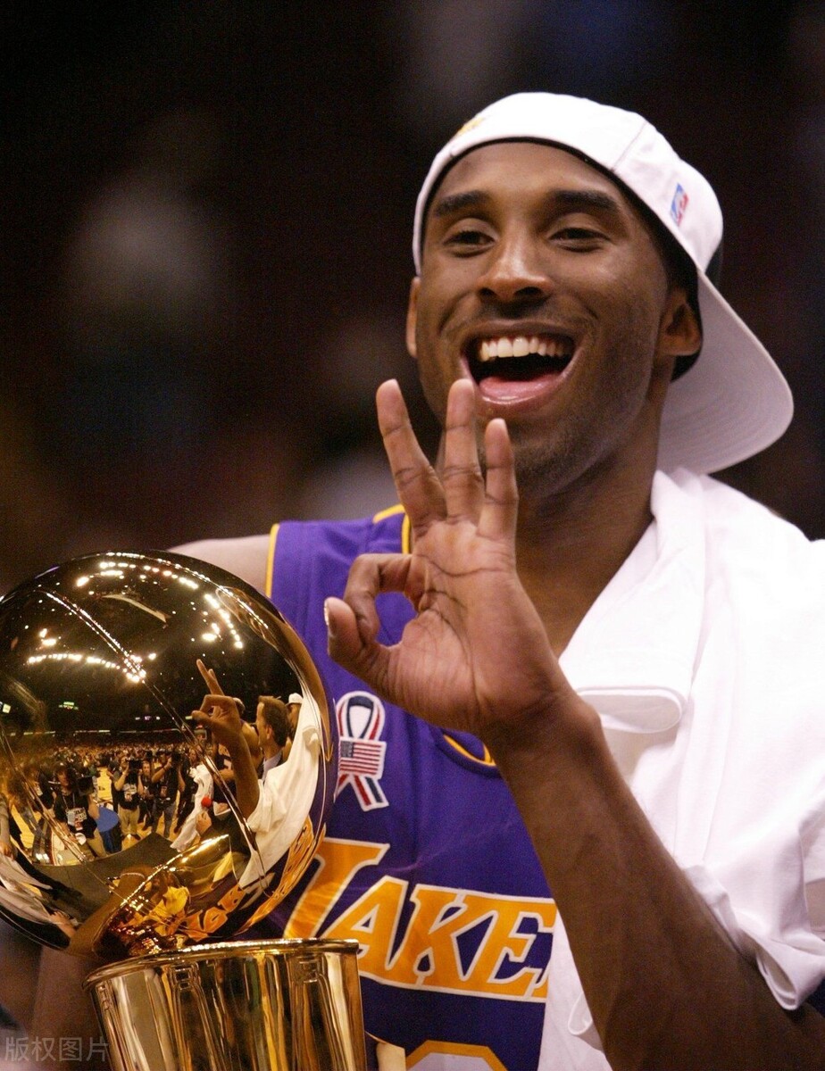 当地时间2002年6月12日,湖人击败篮网夺冠,科比在更衣室内与奖杯庆祝.